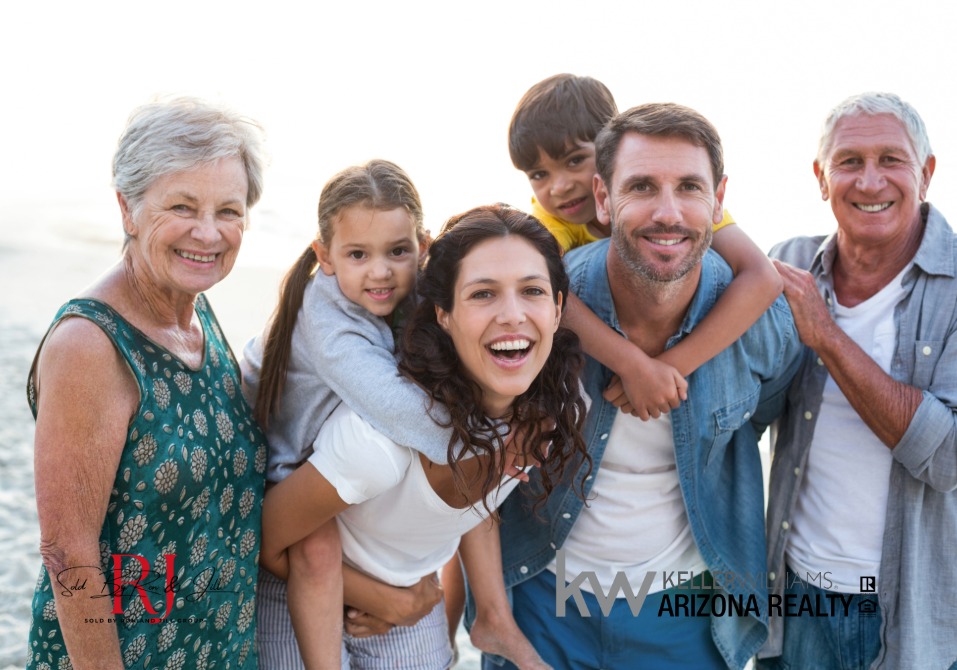 - Sold By Ron And Jill Group - Sold By Ron And Jill Group Family of six posing on a sunny beach, smiling at the camera; three generations include grandparents, parents, and two children.